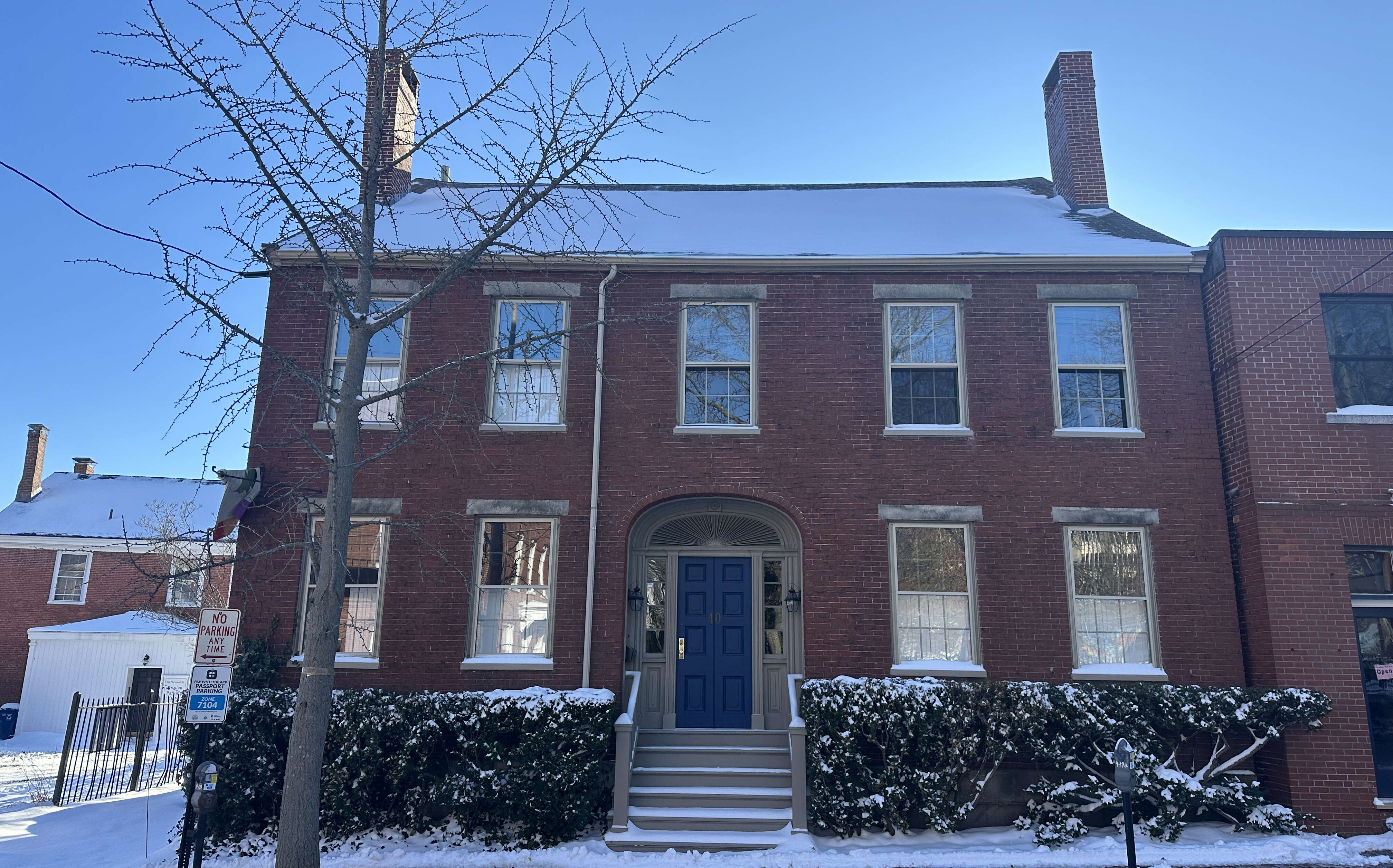An exterior view of a building with snow around it.
