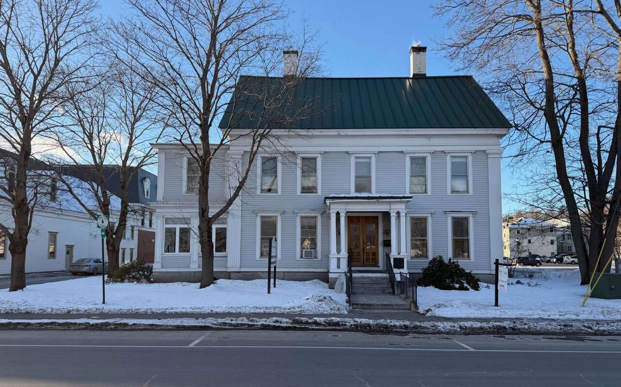 A house has gray siding and white trim.