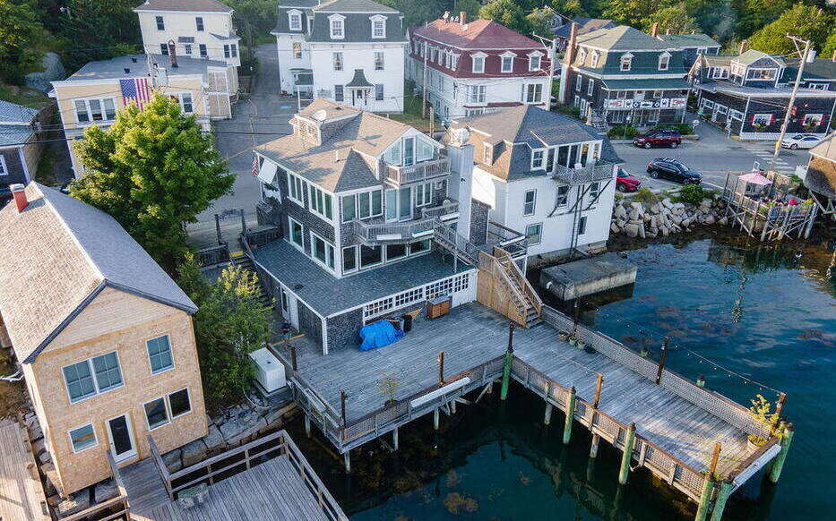 An aerial view of buildings by the water.