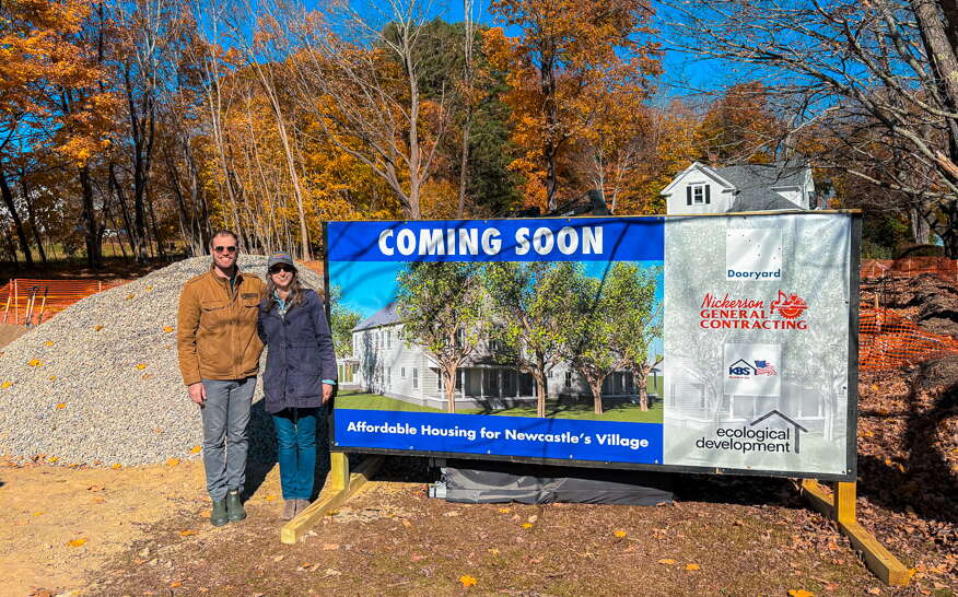 two people standing near building site