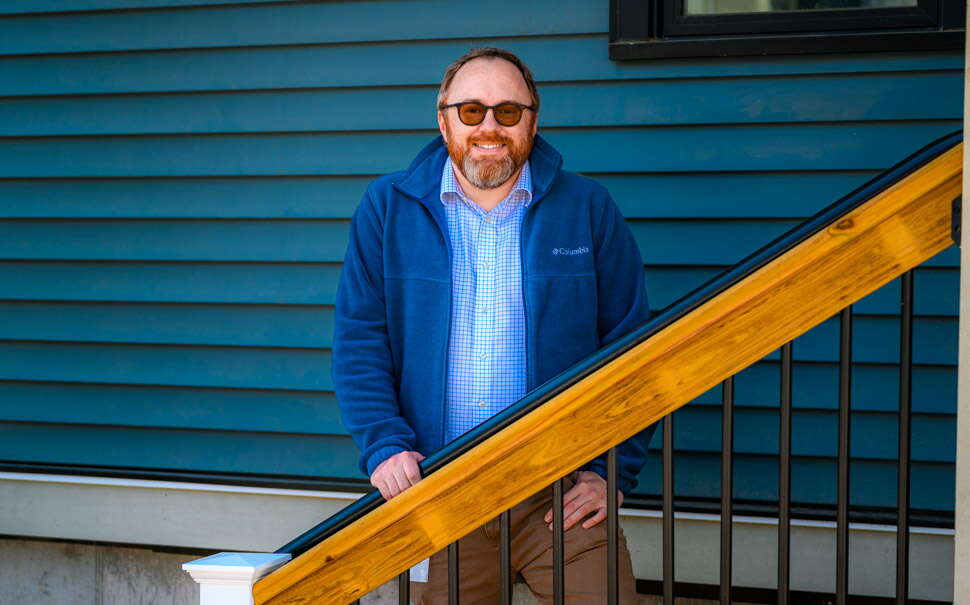 Nate Libby standing on stairs in Auburn.