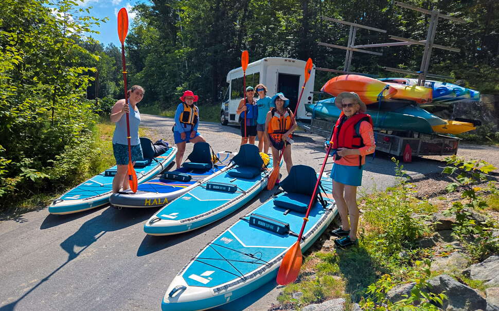 Maine River Runners kayaks on land.