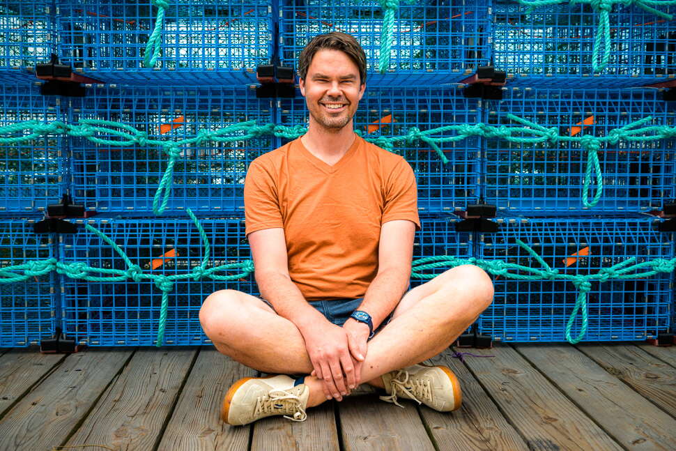 Ben Conniff seated by lobster crates