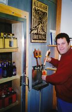 Vintage photo of Rob Tod pouring beer from a tap 