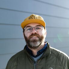 Portrait of Zach Poole with a Maine Brew Bus cap on his head