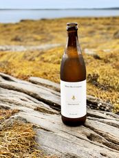 Little Whaleboat beer bottle against outdoor nature setting