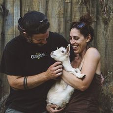 People holding a goat