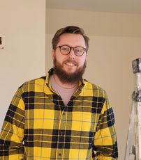 person in yellow flannel smiling