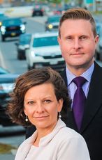 2 people in front of cars