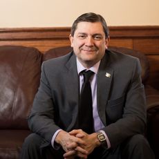 Troy Jackson seated with folded hands 