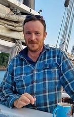 person in plaid shirt on boat