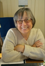 person with glasses smiling