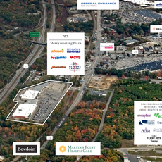 aerial of stores and woods with signs