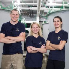 3 people smiling with arms crossed