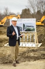 person in hardhat talking with sign