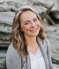 person in gray sweater smiling