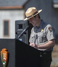 person at podium smiling