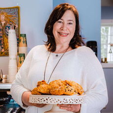 Woman holding a platter of scones