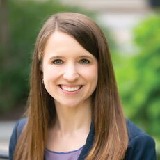 person in blazer smiling