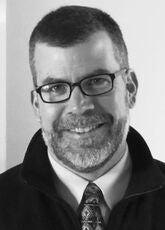 black and white photo of person in tie and fleece