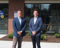 2 people in blue blazers with folded hands