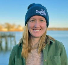 person smiling wearing a hat