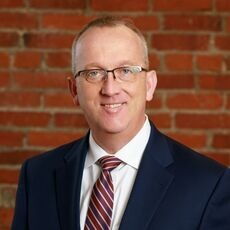 Man in suit and tie wearing glasses