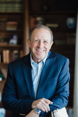 person in blue shirt and blazer wearing watch