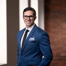 person in blue suit and tie