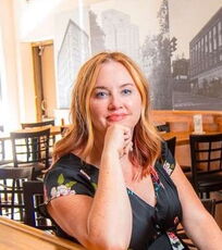 Betsy Lundy sits at a bar.