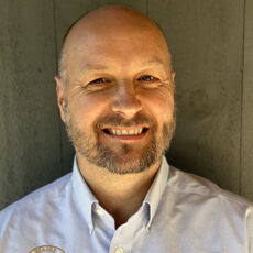 A person poses for a headshot.