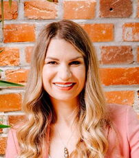 A person poses for a headshot.