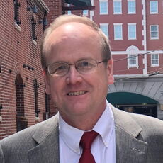 A person poses for a headshot.