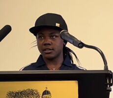 A person stands at a podium.