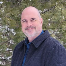 A person poses for a headshot.