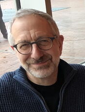 A person poses for a headshot.