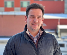 A person poses for a headshot.