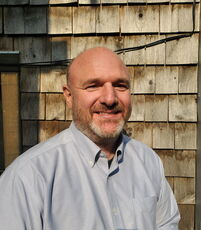 A person poses for a headshot.