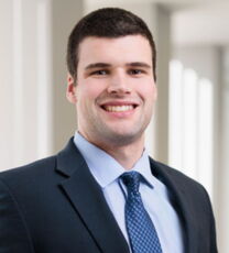 A person poses for a headshot.