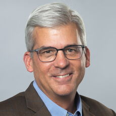 A person poses for a headshot.