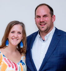 Two people pose.