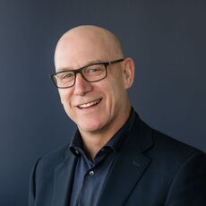 A person poses for a headshot