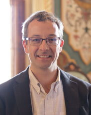 A person poses for a headshot.