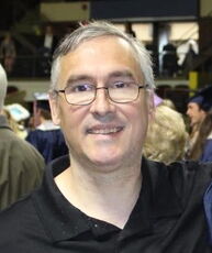 A person poses for a headshot.