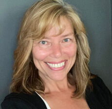 A person poses for a headshot.