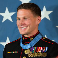 A person poses for a headshot.