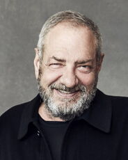 A person poses for a headshot.