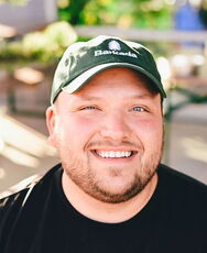 A person poses for a headshot.