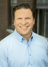 A person poses for a headshot.