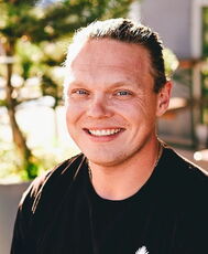 A person poses for a headshot.